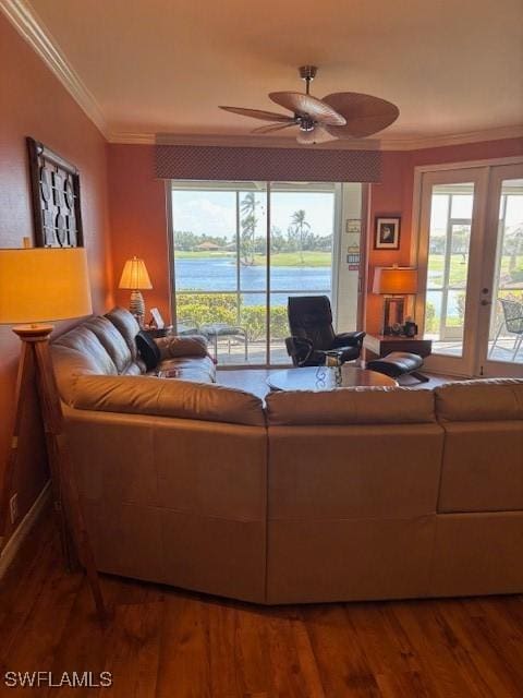 living room featuring a ceiling fan, ornamental molding, and wood finished floors