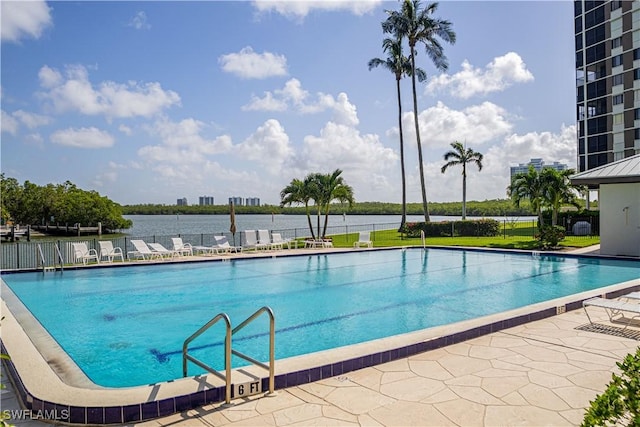 community pool with fence and a patio