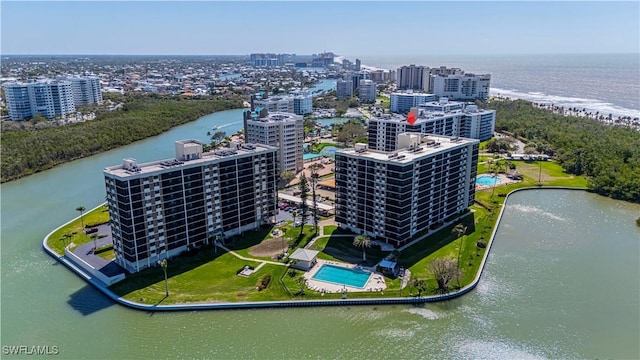 birds eye view of property featuring a water view and a view of city