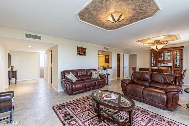 living room with light tile patterned floors, visible vents, and baseboards