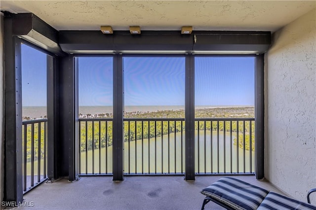 15 Bluebill Ave Unit 803, Naples, FL 34108 - unfurnished sunroom featuring a water view