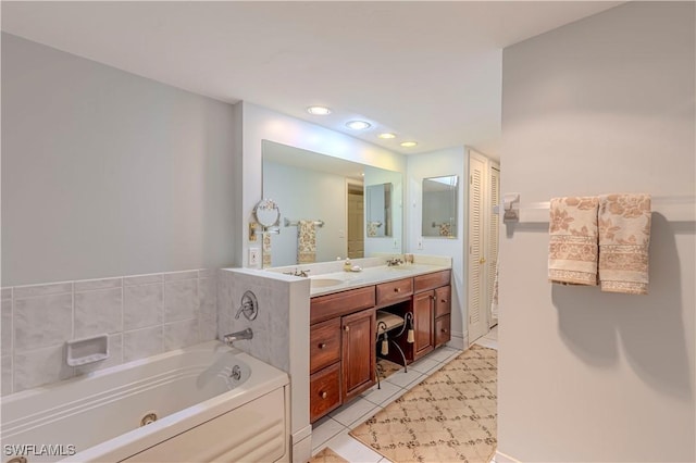 full bath featuring recessed lighting, tile patterned floors, double vanity, a sink, and a jetted tub