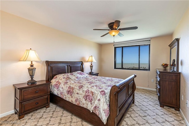 bedroom with a ceiling fan and baseboards