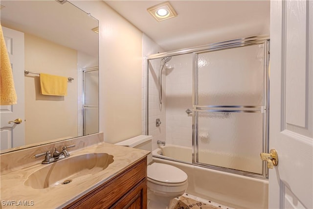 full bathroom with vanity, toilet, and shower / bath combination with glass door