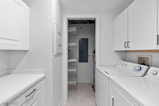 laundry room with electric panel, washing machine and dryer, cabinet space, light tile patterned floors, and baseboards