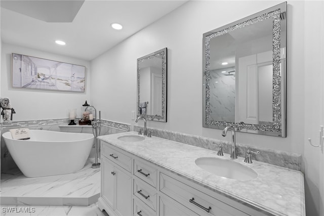 full bathroom featuring recessed lighting, a soaking tub, marble finish floor, and a sink