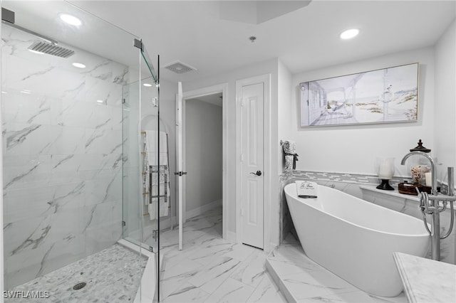 full bath featuring a freestanding tub, visible vents, marble finish floor, recessed lighting, and a marble finish shower