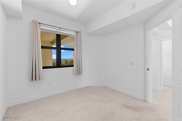 empty room featuring baseboards and carpet