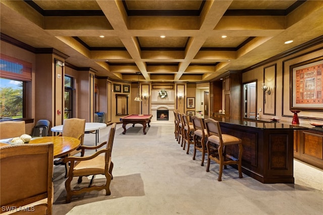 bar featuring beamed ceiling, indoor wet bar, light carpet, a decorative wall, and coffered ceiling