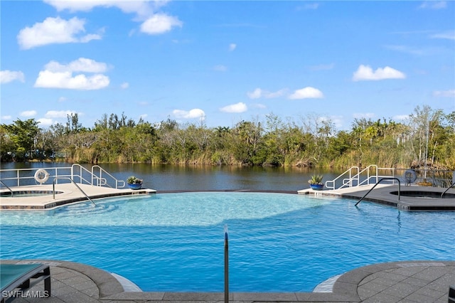 view of pool featuring a patio, an infinity pool, and a water view