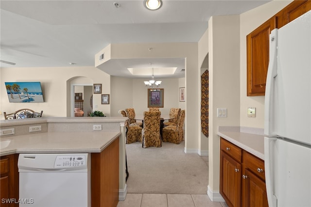 kitchen featuring brown cabinetry, white appliances, light countertops, and open floor plan