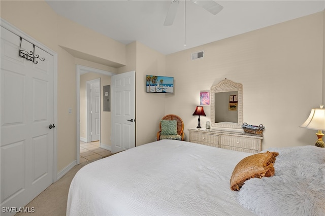 bedroom with light carpet, ceiling fan, visible vents, and baseboards