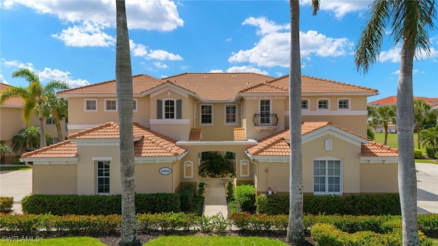 mediterranean / spanish-style home featuring a tile roof and stucco siding