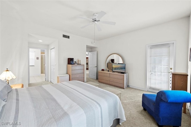 bedroom featuring multiple windows, baseboards, visible vents, and light carpet