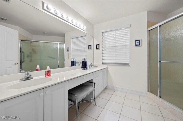 bathroom with a sink, a stall shower, double vanity, and tile patterned flooring