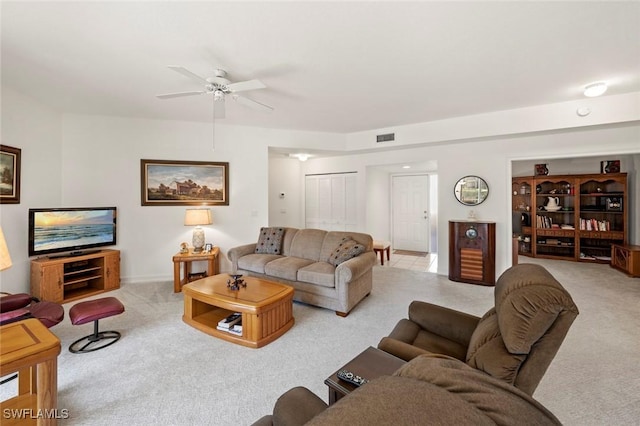 carpeted living area with visible vents and ceiling fan