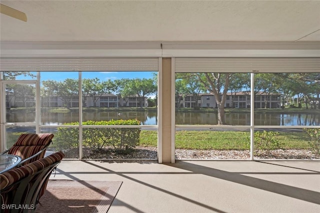 unfurnished sunroom with a water view