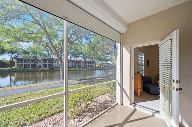 sunroom with a water view and a wealth of natural light