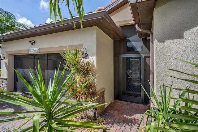 entrance to property featuring stucco siding