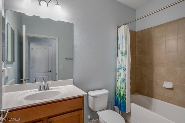 full bathroom with a textured wall, vanity, toilet, and shower / tub combo with curtain