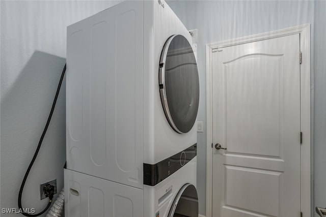 clothes washing area featuring laundry area and stacked washer / drying machine