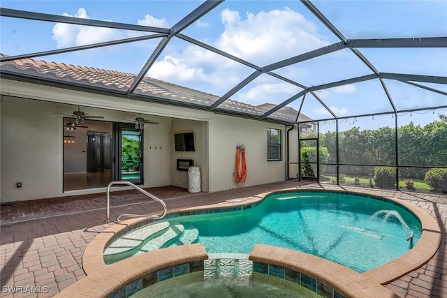 view of pool with a lanai, a pool with connected hot tub, a ceiling fan, and a patio