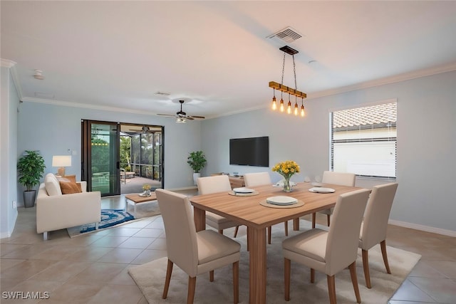 dining room with baseboards, light tile patterned flooring, visible vents, and crown molding