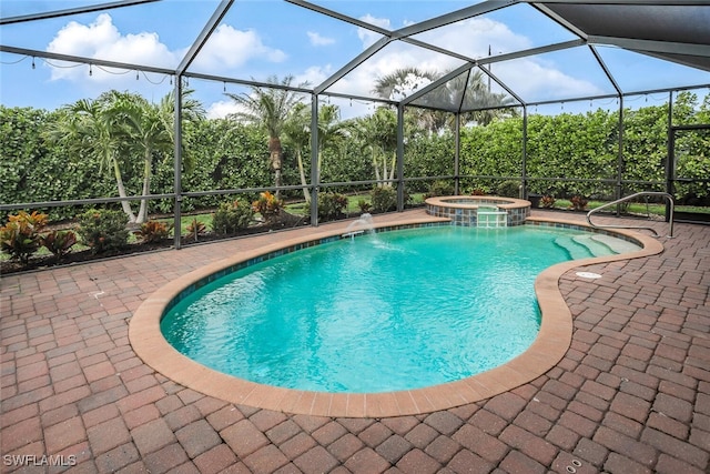 view of swimming pool featuring glass enclosure, a pool with connected hot tub, and a patio