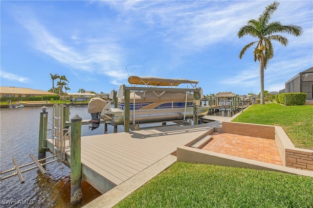 view of dock with a water view, boat lift, a residential view, and a lawn