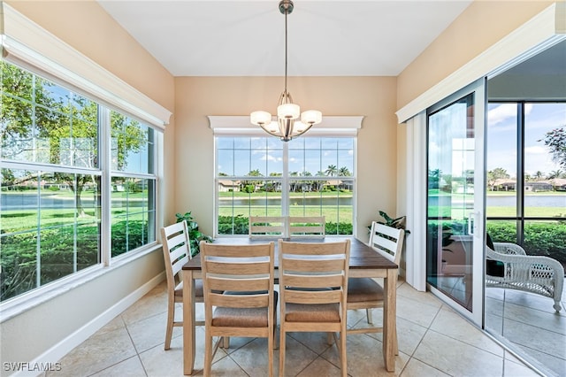 dining area with an inviting chandelier, baseboards, and a wealth of natural light