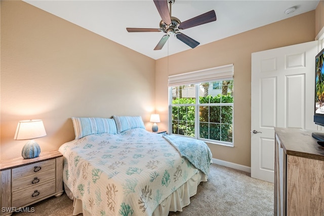 carpeted bedroom featuring ceiling fan and baseboards