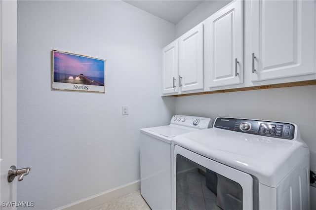 laundry area with washer and dryer, cabinet space, and baseboards