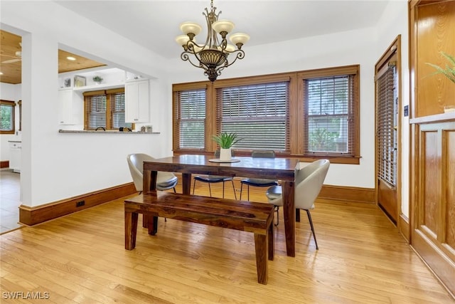 dining area with baseboards, recessed lighting, light wood-style flooring, and a notable chandelier