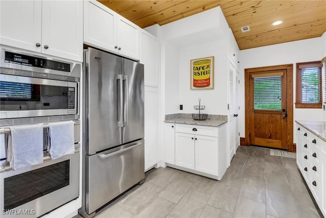 kitchen featuring wood ceiling, light stone countertops, stainless steel appliances, white cabinetry, and recessed lighting