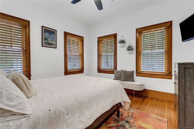 bedroom featuring wood-type flooring, ceiling fan, and baseboards