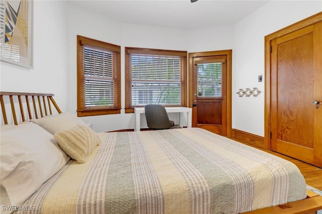 bedroom featuring baseboards and wood finished floors