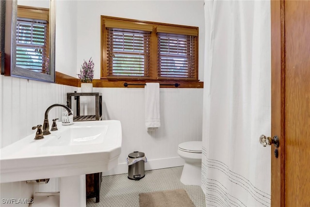 bathroom with toilet and tile patterned floors