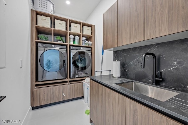 laundry room featuring laundry area, a sink, and washer and clothes dryer