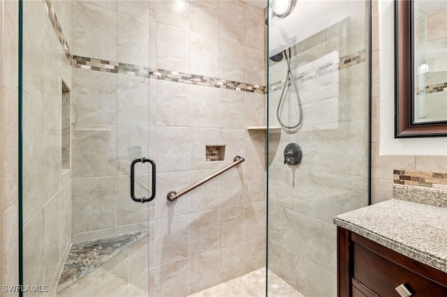 bathroom featuring a stall shower and vanity