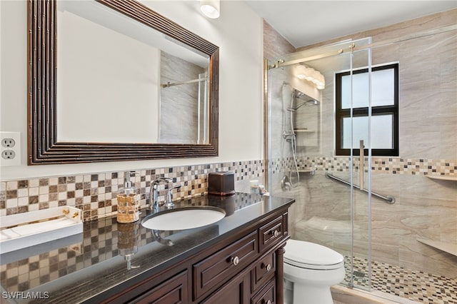 bathroom featuring a shower stall, vanity, and toilet