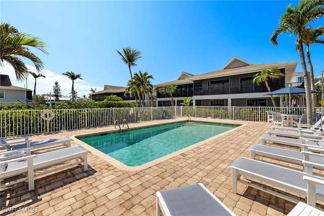 pool featuring a patio area and fence