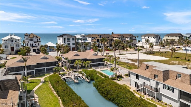 drone / aerial view featuring a residential view and a water view