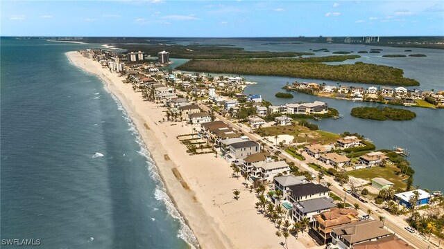 drone / aerial view featuring a view of the beach and a water view