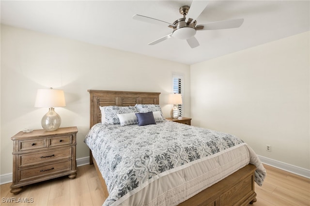 bedroom with light wood finished floors, ceiling fan, and baseboards