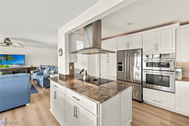 kitchen featuring light wood-type flooring, stainless steel appliances, open floor plan, and island range hood