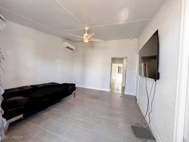 living area with ceiling fan, a wall mounted AC, and baseboards