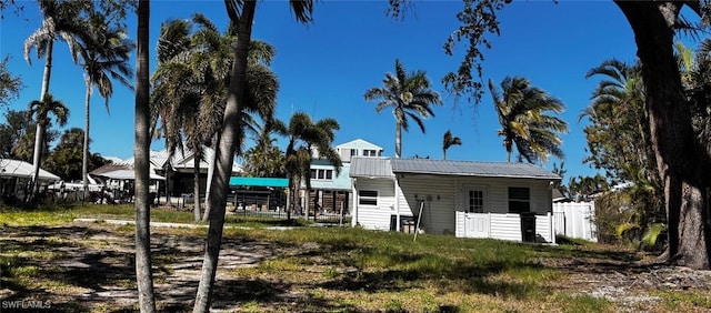 view of front facade with metal roof and fence