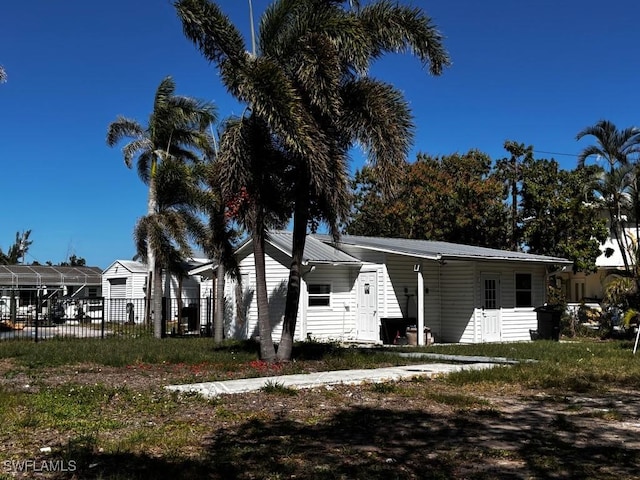 view of front of home featuring fence