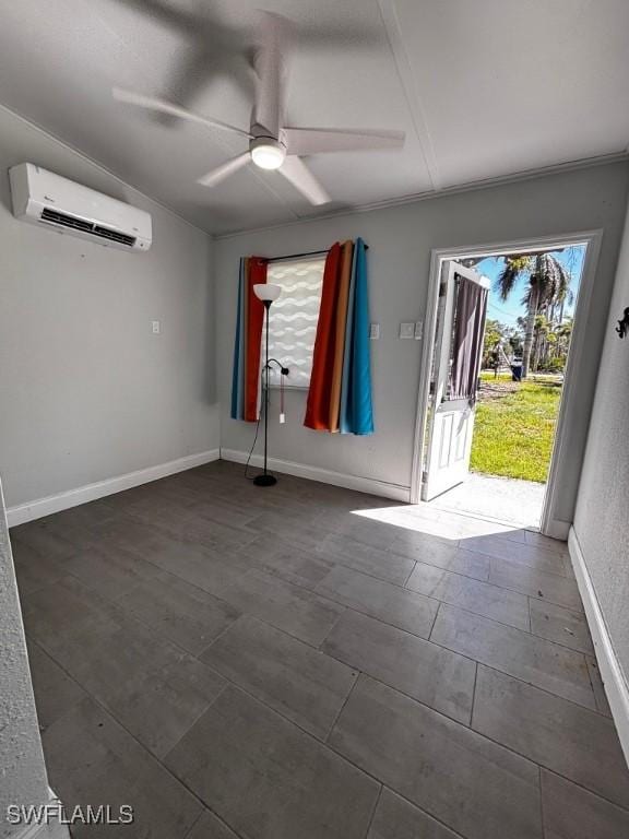 unfurnished room featuring a ceiling fan, a wall mounted air conditioner, and baseboards