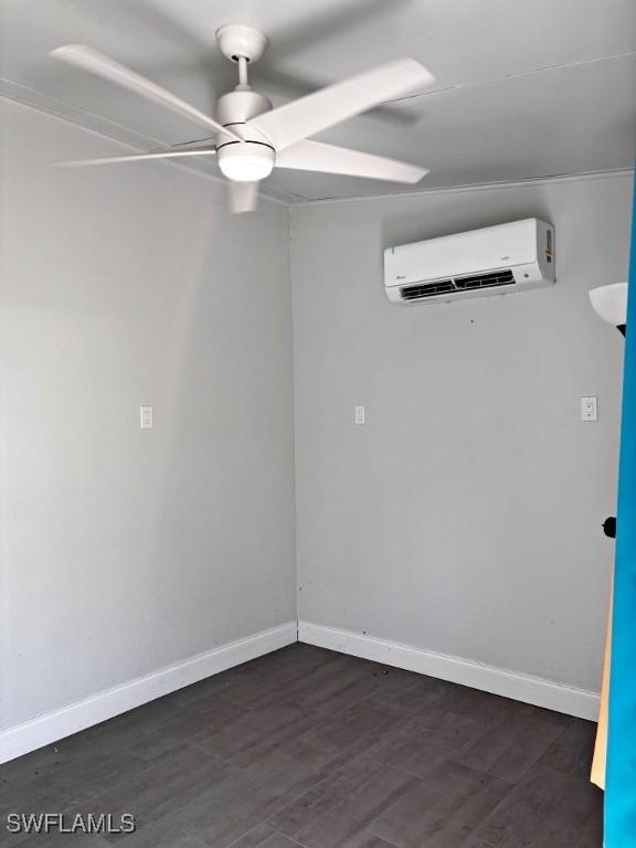 unfurnished room with a ceiling fan, baseboards, a wall mounted air conditioner, and dark wood-type flooring